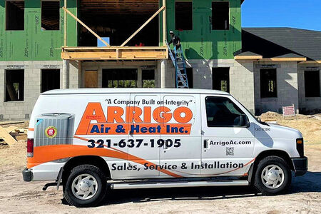 New Construction AC Installation in Florida with Arrigo Van and a worker on a ladder on a new home being built.
